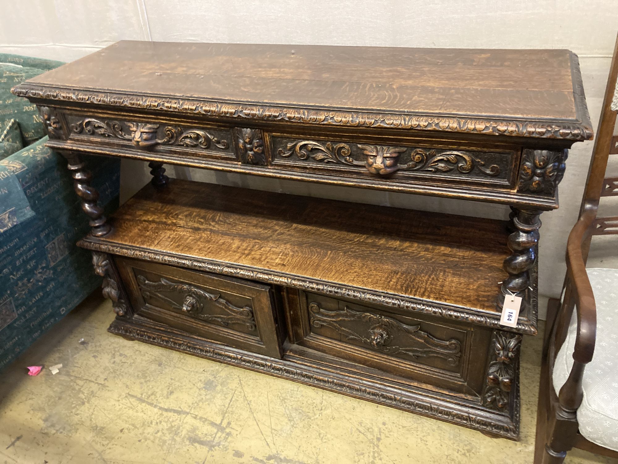 A late 19th century Flemish carved oak buffet, width 136cm, depth 40cm, height 94cm